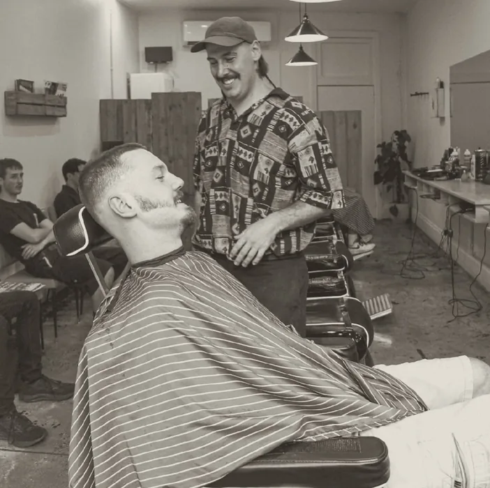 Barber and client sharing a laugh in the chair